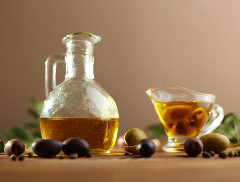 A,Beautifully,Arranged,Olive,Oil,Bottle,Alongside,Fresh,Olives,And